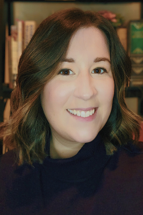 Headshot of young woman in front of bookcase